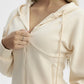 Beige hoodie with a zipper being pulled open on a white background