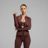 Woman wearing a brown athletic outfit on a gray background